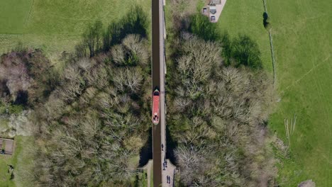 Un-Barco-Estrecho-Que-Cruza-El-Acueducto-Pontcysyllte-Famoso-Diseñado-Por-Thomas-Telford,-Ubicado-En-La-Hermosa-Campiña-Galesa,-Famosa-Ruta-Del-Canal