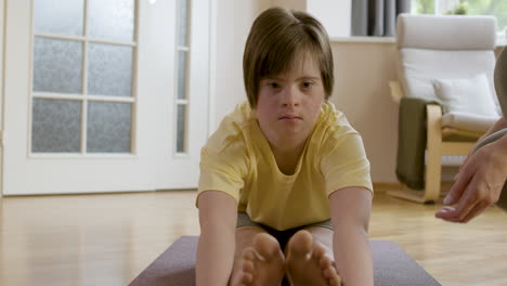 woman teaching and helping young girl with flexibility