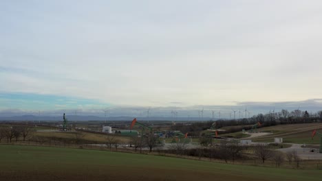 [drone]rotating shot around multiple oil derricks moving