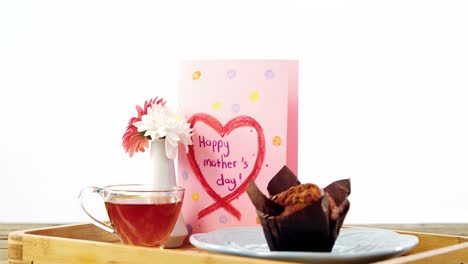 Cupcake,-tea,-flower-vase-and-happy-mothers-day-greetings-card-in-tray