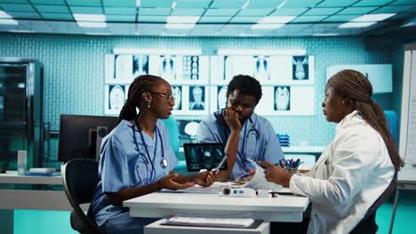 group of healthcare specialists in scrubs analyzing results with doctor
