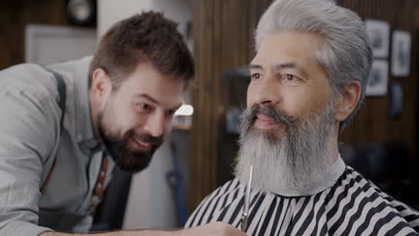 barber giving haircut to senior man