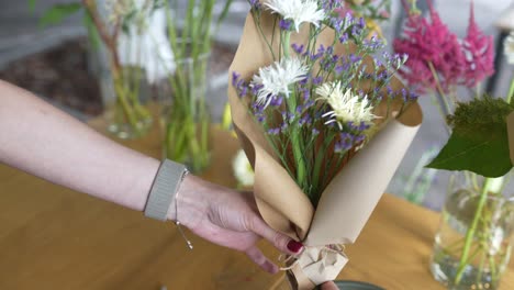 woman arranging a flower bouquet