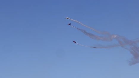 planes performing stunts with smoke trails