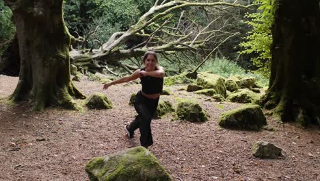 Enthusiastic-capoeira-dancer-doing-ginga,-forest-meadow.-Slowmo