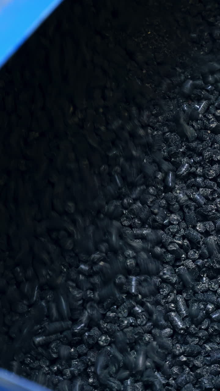 Compressed pellets for use as an eco-friendly renewable. Close up on a pile of compressed pellets for use as an eco-friendly renewable. Vertical video