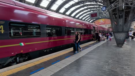 passengers boarding a train at milan station