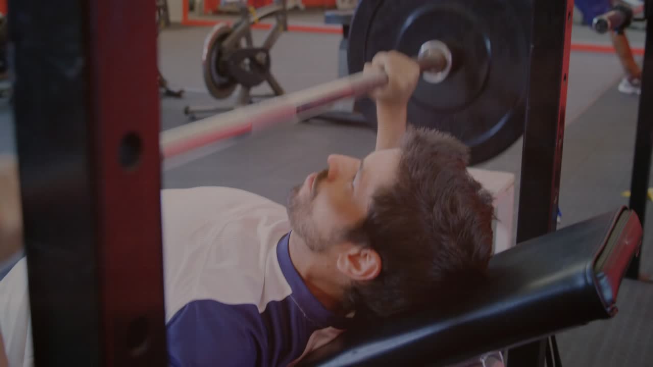 Man gripping barbell and lowering then pressing, doing bench press for fitness, brain overlaying