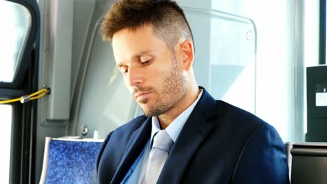 Businessman-using-mobile-phone-while-travelling