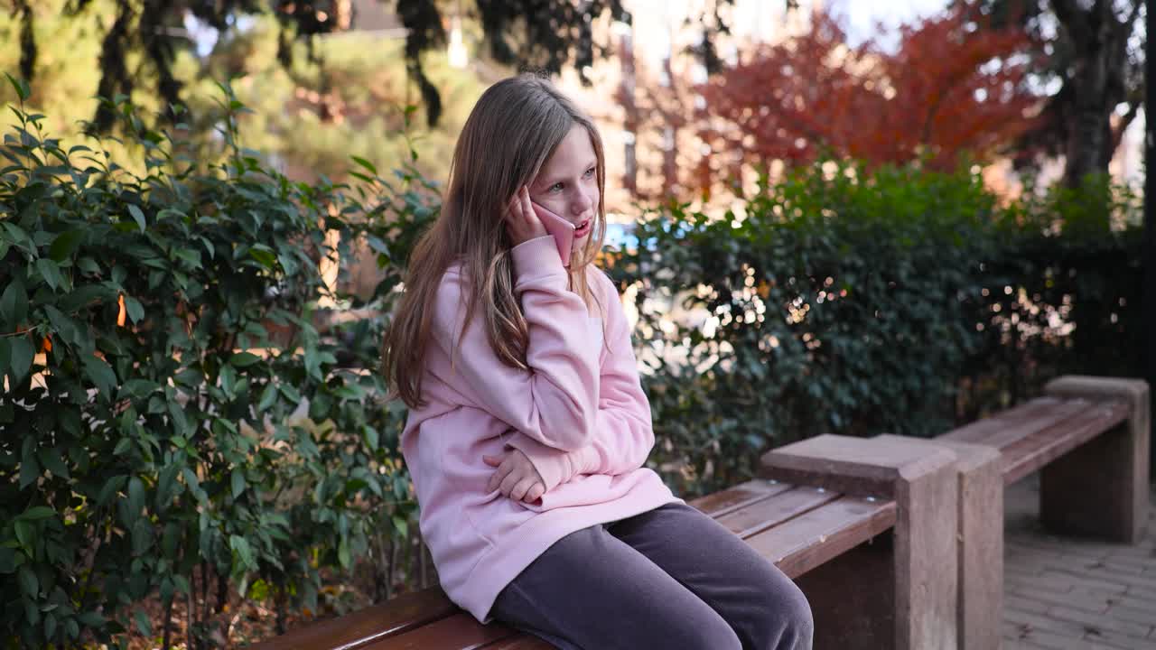 Girl talking on phone in park
