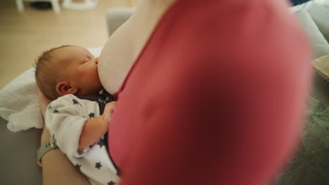 mother breastfeeding newborn baby
