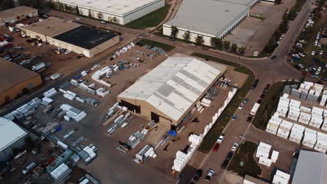 Revealing-drone-shot-of-the-warehouse-with-construction-supplies-in-Calgary,-Alberta