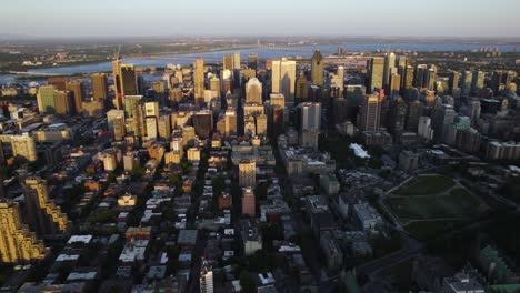 Panoramic-drone-shot-of-the-Centre-Ville-district-of-Montreal-city,-sundown-in-Canada