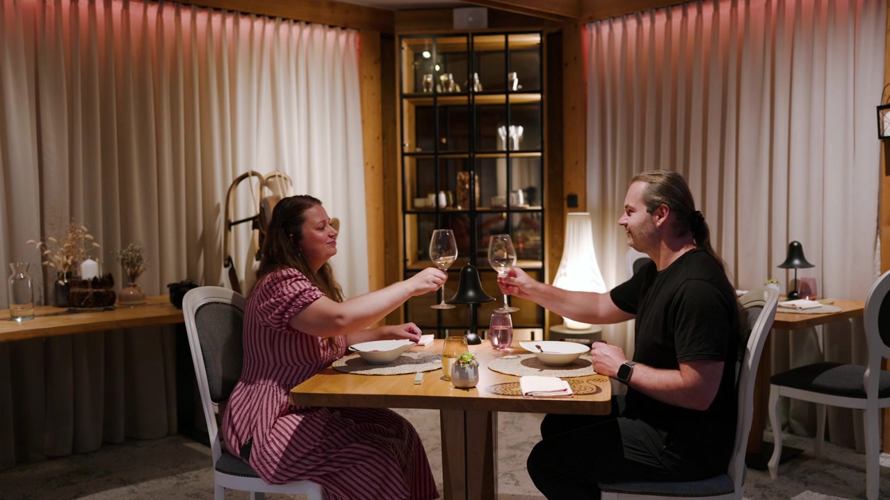 Couple Enjoys Fine Dining At A Restaurant With Locally Prepared Food In An Elegant Dining Setting. Static Shot