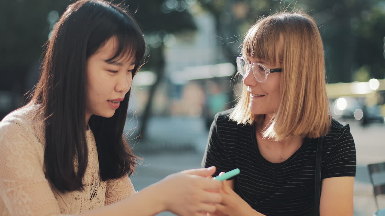 Two friends looking at a phone