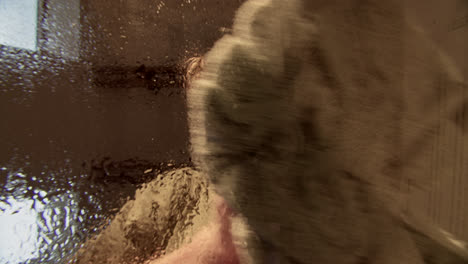 changing perspectives: man behind wet glass