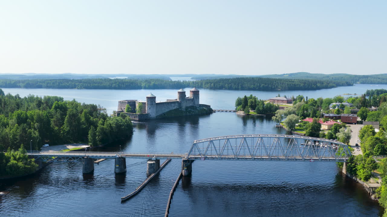 Establishing drone shot approaching the Olavinlinna fort, summer in Savo, Finland