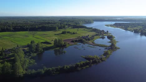 aerial panning shot of a meandering river and swampland in rural lithuania