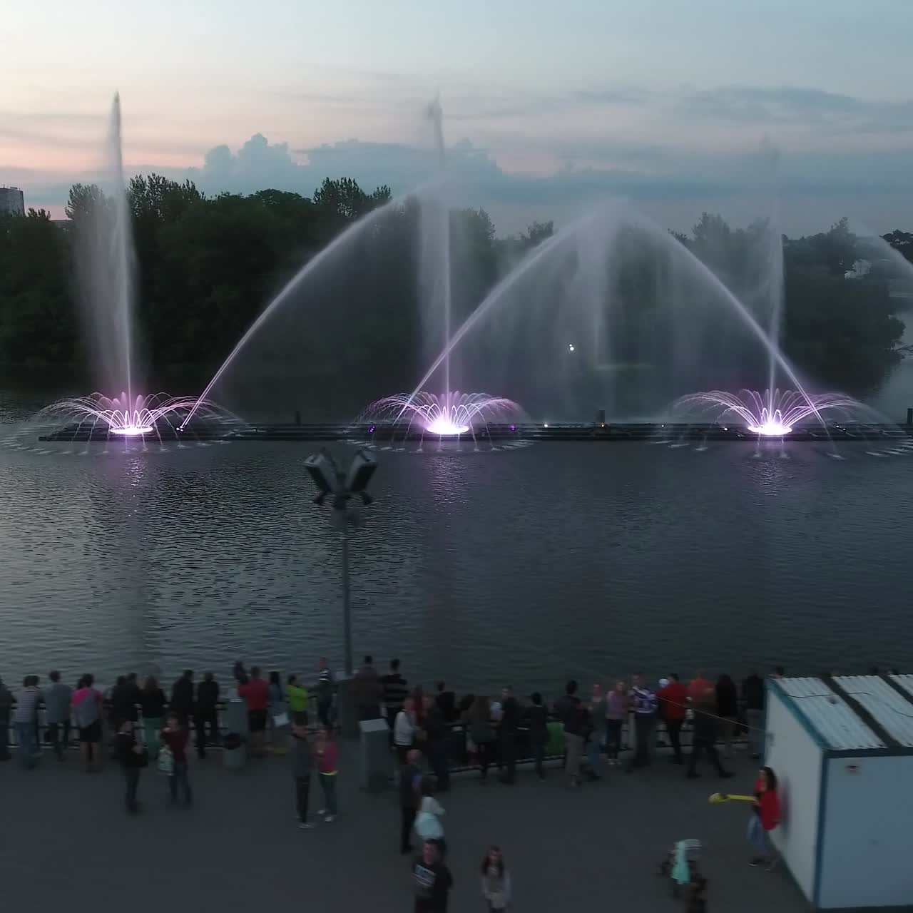 Beautiful Dancing Fountain. Aerial shot of the colorful illuminated musical fountain at dusk