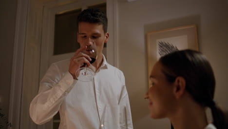 Young-lovers-toasting-glasses-at-night-apartment-closeup.-Pair-drinking-wine