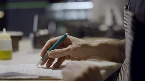person writing on a notepad