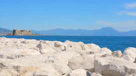 Overlooking-coastline-and-sea-with-Castel-dell'Ovo-in-the-distance-in-the-background-Naples,-Italy