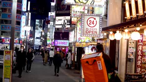 pedestrians walking on a brightly lit urban street