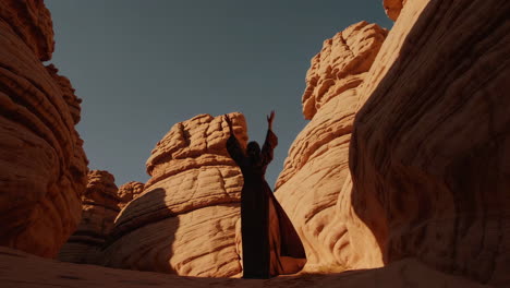 a solitary figure in a flowing robe amidst majestic desert canyons