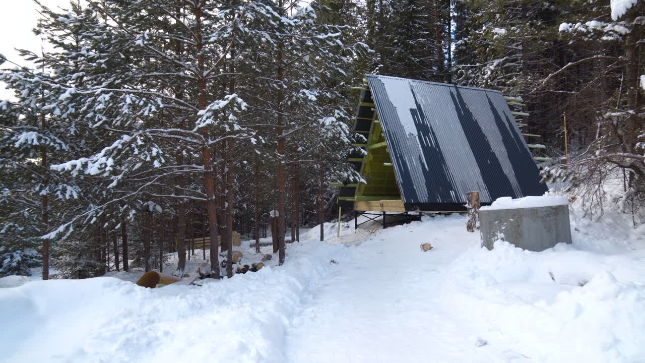 Snowy Winter Cabin Under Construction in the Forest