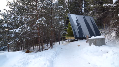 snowy winter cabin under construction in the forest