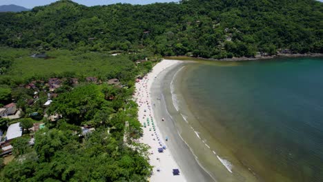 aerial overview of people at the barra do sahy beach, sunny day in brazil