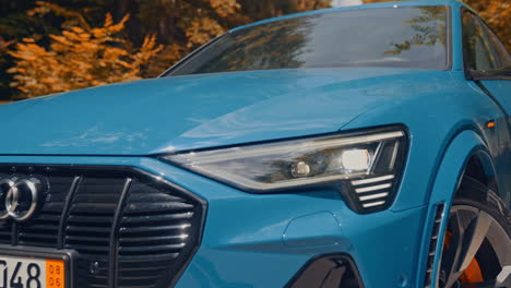 presentation of a blue audi e-tron, compact luxury crossover suv. modern new cars for sale