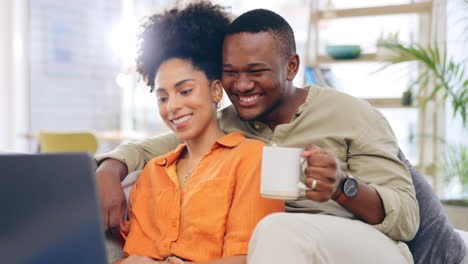 Laptop,-couple-and-laughing-in-home-with-coffee