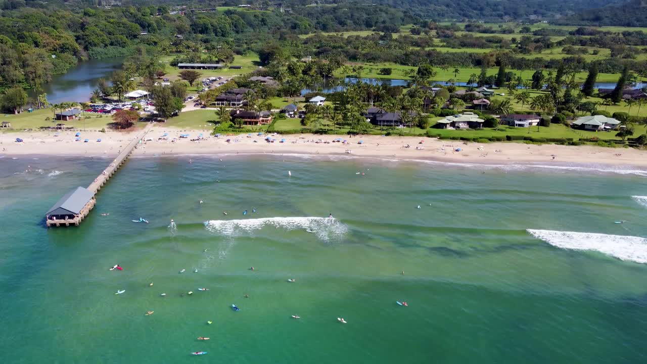 Aerial View of a Tropical Beach with Surfers