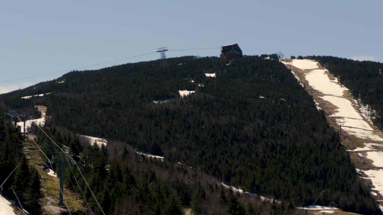 Drone Aerial ski mountain during summer with snow melt and skiing chairlift tram building HD 30p