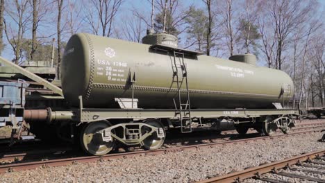 vintage us army tank car on railroad tracks