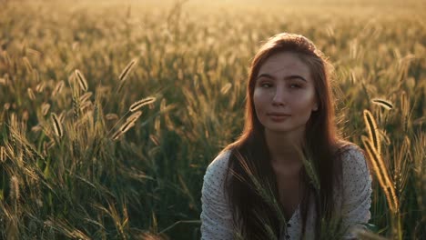woman in a wheat field at sunset