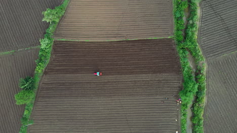 aerial view of a tractor working in a farm field