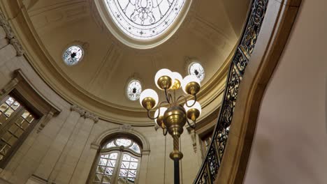 renovated interior of a historic palace with ornate windows and a skylight, 4k crane shot