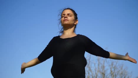 Girl-in-sportswear-meditating-in-park