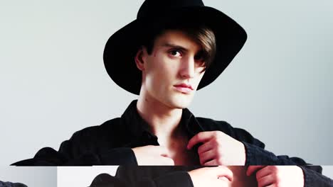 androgynous man posing against grey background