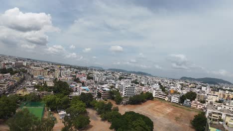 drone view of rural amaravathi’s highway, gound and farmlands under clear blue skies.
