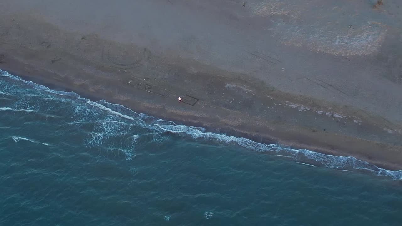 Peaceful aerial view of a beach in Greece with gentle waves