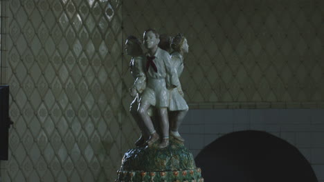 porcelain statuette of soviet children pioneers in ornate spa room