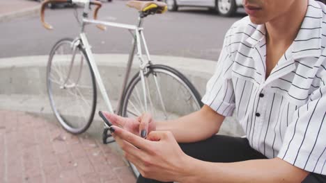 Mixed-race-man-using-his-phone-outside