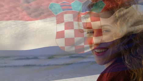 animation of flag of croatia over caucasian woman at beach