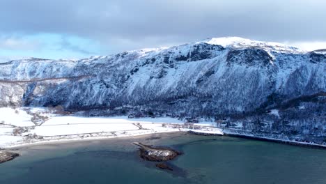 this 4k aerial video captures the winter magic of bodø, norway. snowy mountains, frozen fjords, and arctic landscapes create a mesmerizing winter wonderland.