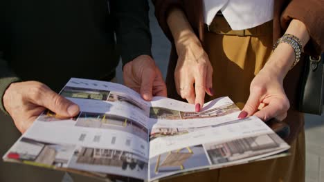 people reviewing outdoor furniture catalog