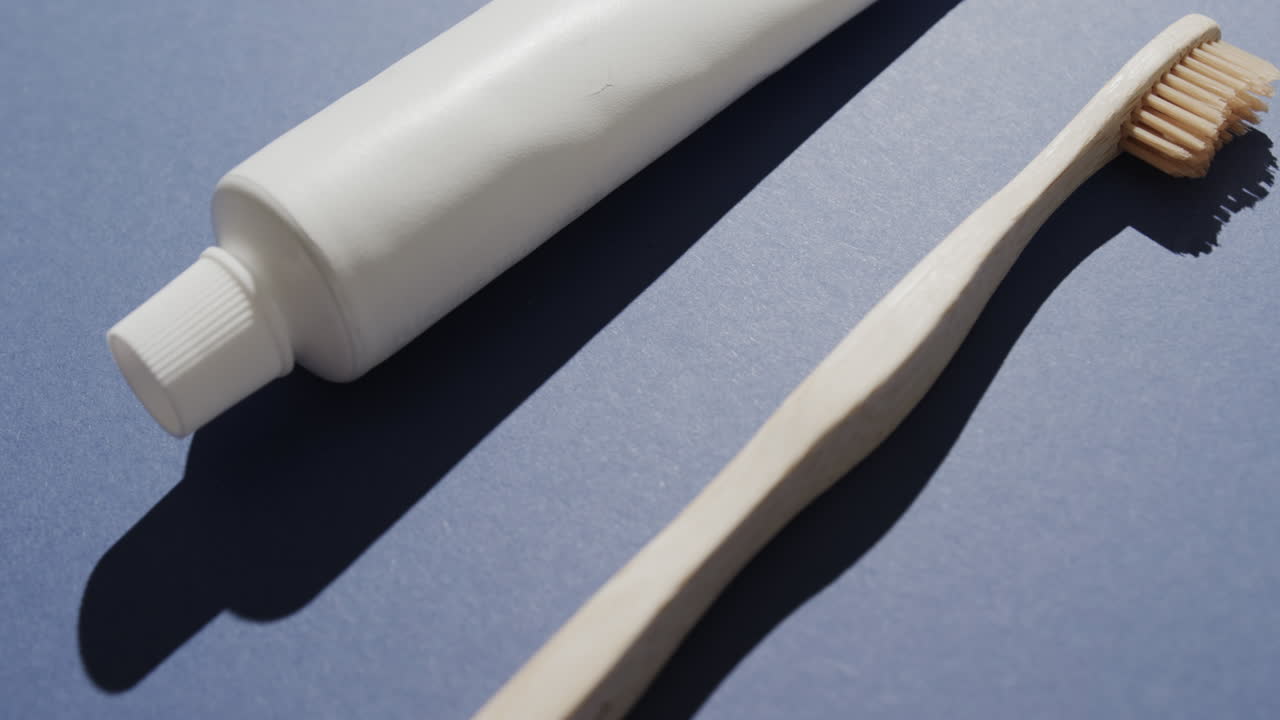 Close up of toothbrush and toothpaste on blue background