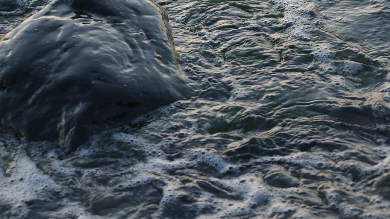 Water splashing on the rocks on the sea shore